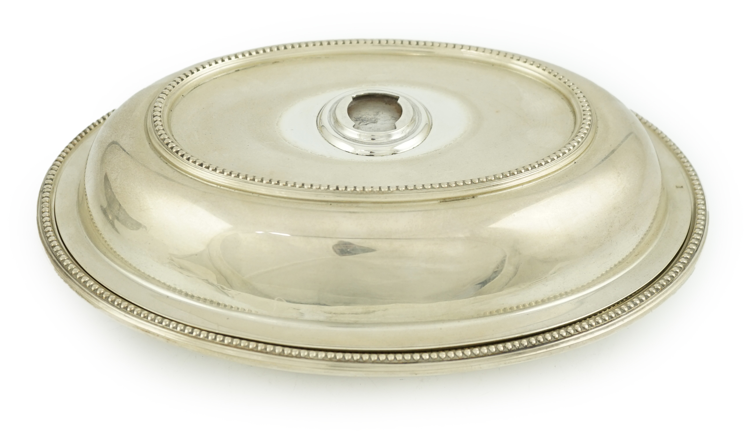 An Edwardian silver oval entreé dish and cover, lacking handle, by Goldsmiths & Silversmiths Co Ltd
